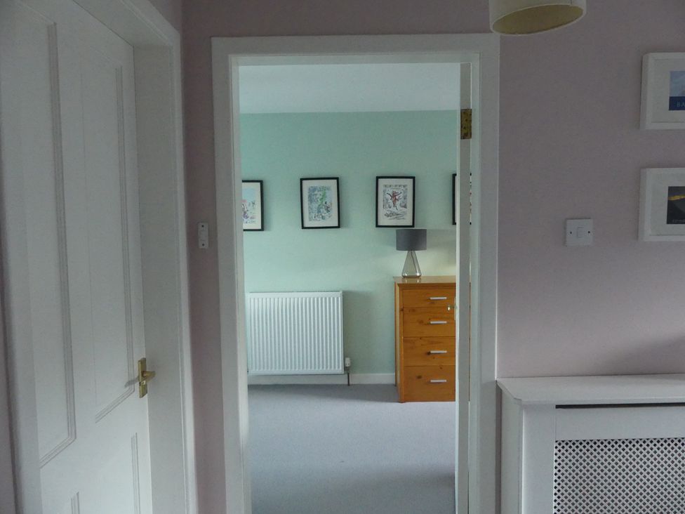 A hallway with a door leading to a room at Charming Cottage in North Berwick
