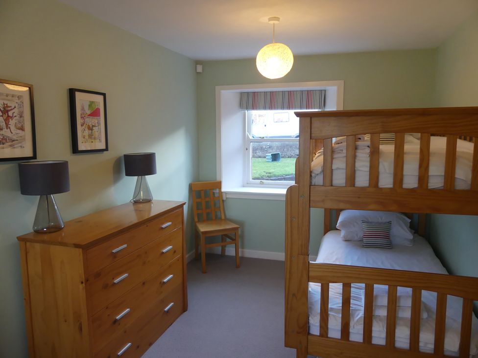 A bedroom with a bunk bed and a dressing table at Charming Cottage in North Berwick with Sea Views