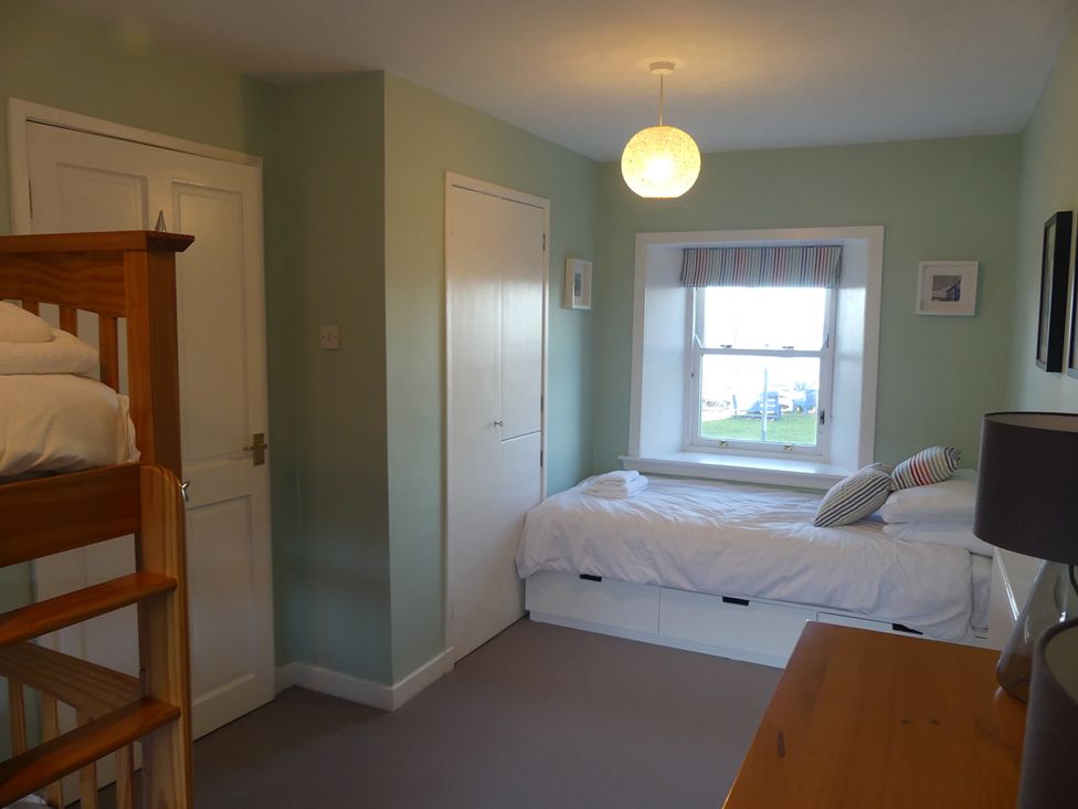 A bedroom with a bunk bed and a single bed at Charming Cottage in North Berwick with Sea Views