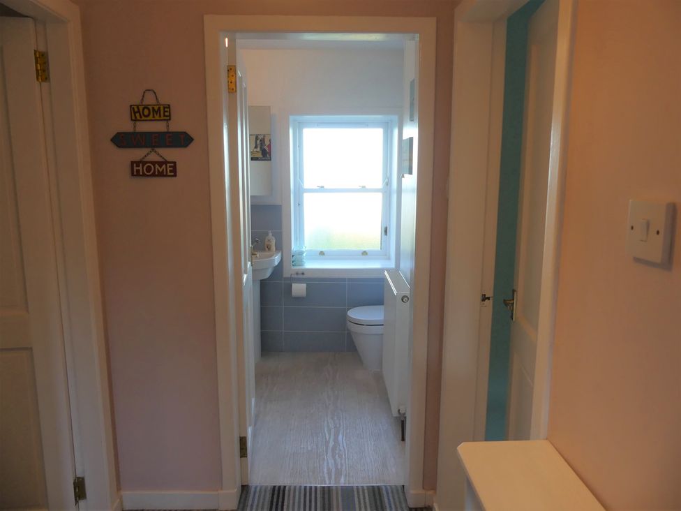 A bathroom with a toilet and sink visible at Charming Cottage in North Berwick