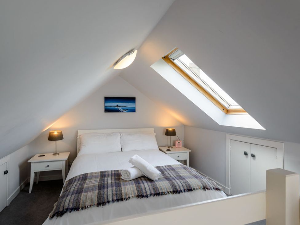 A bedroom with a bed and nightstands at Charming Cottage in North Berwick with Sea Views North Berwick