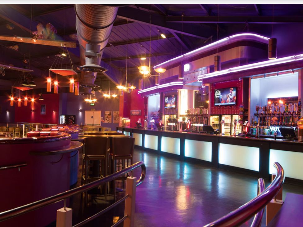 A bar with stools and drinks on display at Caravan Sleeps 5 - Decking, Parking, Pet Friendly in Blackpool