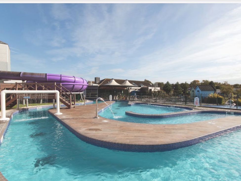 An outdoor pool area with a water slide at Caravan Sleeps 5 - Decking, Parking, Pet Friendly in Blackpool