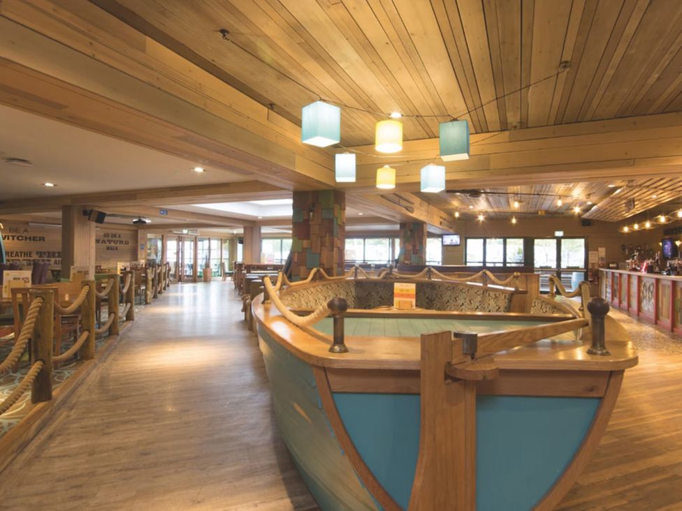 An indoor area with a boat centerpiece and seating at Caravan Sleeps 5 - Decking, Parking, Pet Friendly, Blackpool