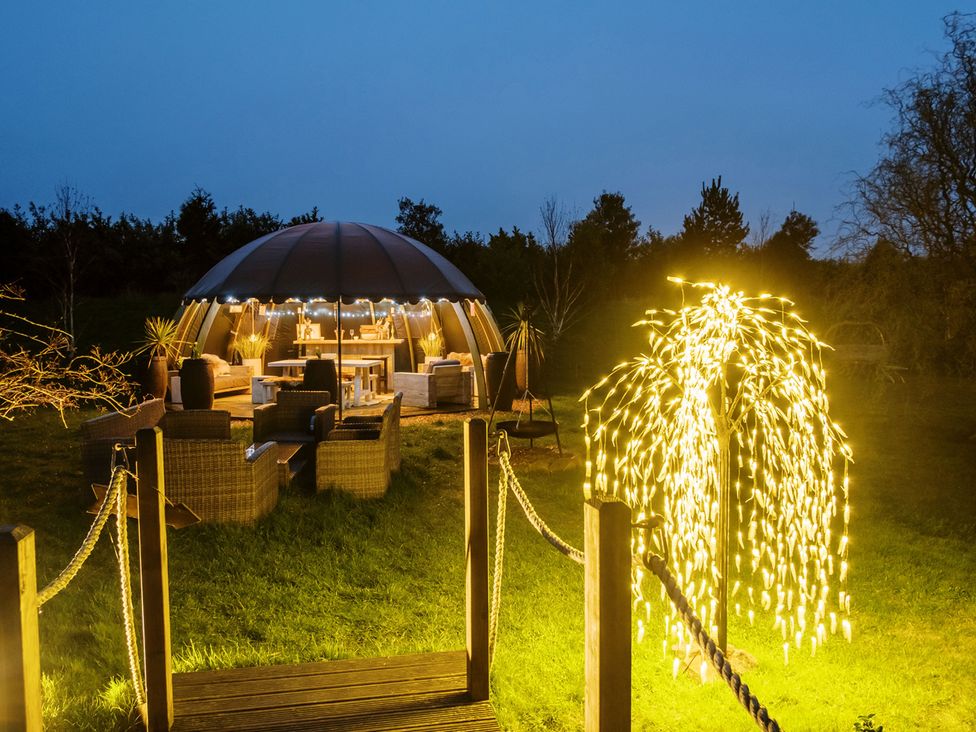 A garden with a dome structure and outdoor furniture at Shepherd's Hut- Hot Tub- Wellness Spa- Wood Burner Nottingham