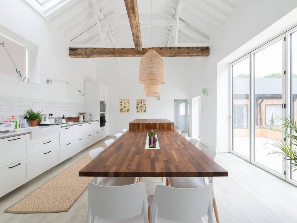 A kitchen with a dining table and chairs at Simple Coastal Luxury near Southwold