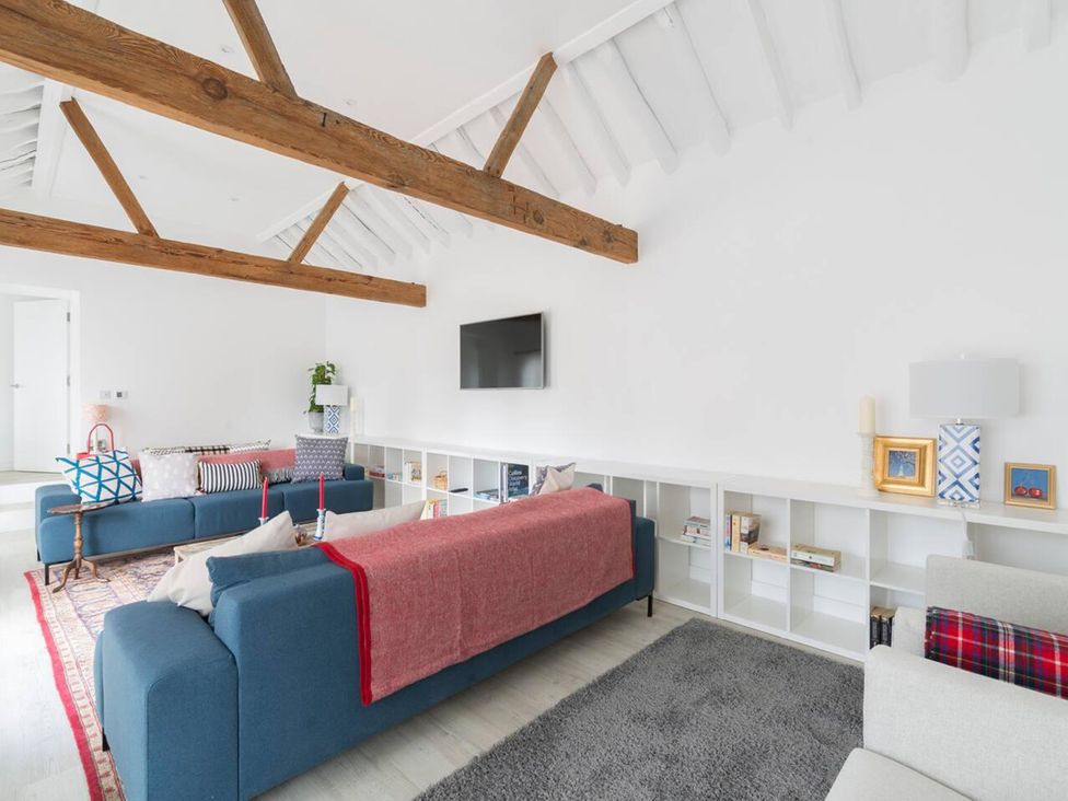 A living room with sofas and a television at Simple Coastal Luxury near Southwold sleeps 10 near Southwold