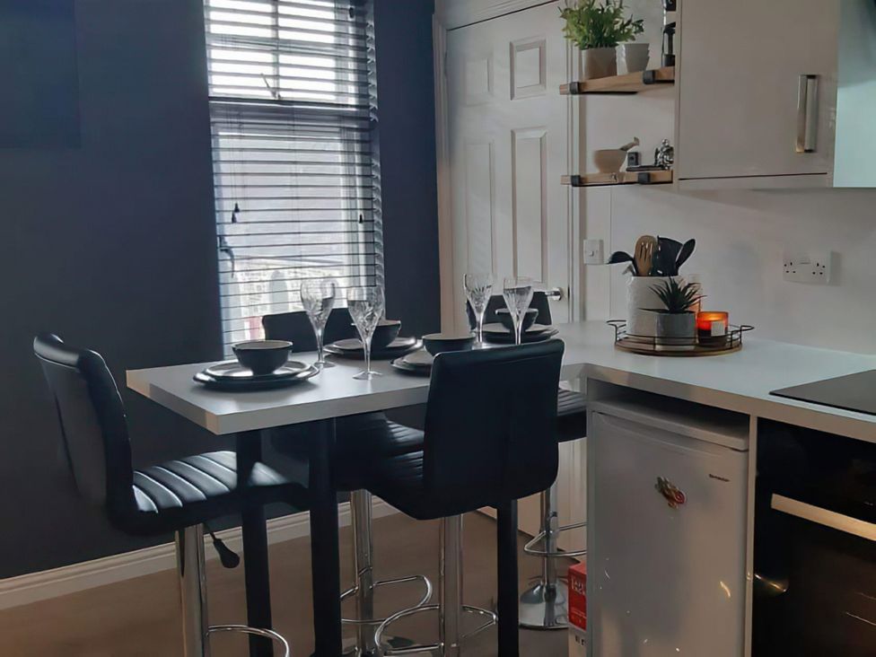 A kitchen with a table and chairs set for dining at Modern Apartment - Sleeps 4 - Centrally located, Lanark