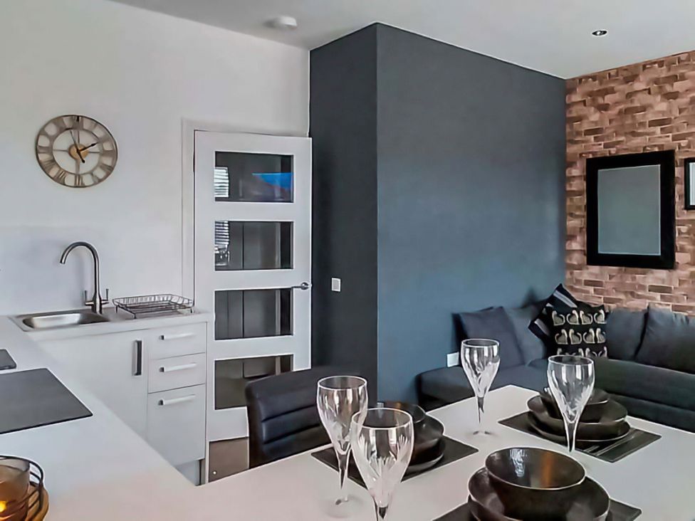 A dining room with a sink and dining table at Modern Apartment - Sleeps 4 - Centrally located in Lanark