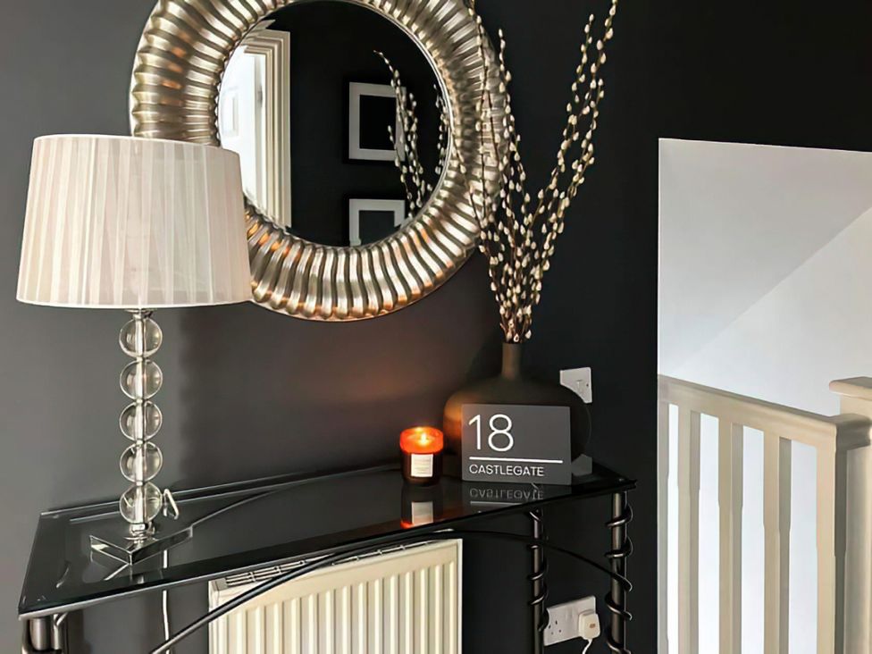 A hallway with a mirror, lamp, and console table at Modern Apartment - Sleeps 4 - Centrally located Lanark
