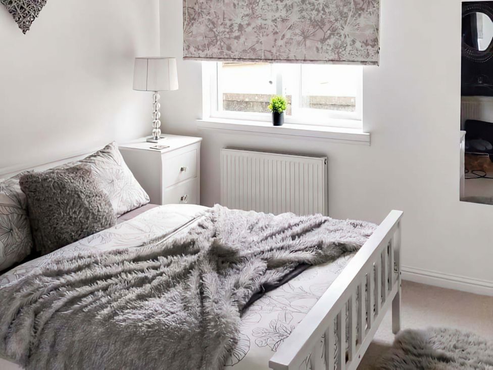 A bedroom with a bed and nightstand at Modern Apartment - Sleeps 4 - Centrally located in Lanark