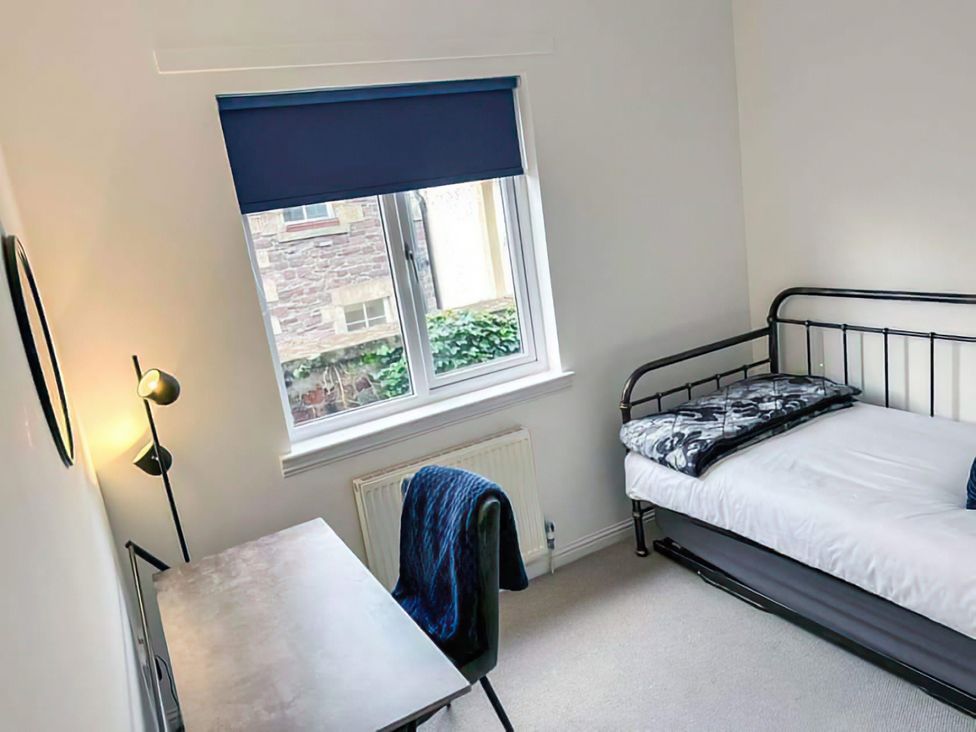 A bedroom with a bed and desk at Modern Apartment - Sleeps 4 - Centrally located in Lanark