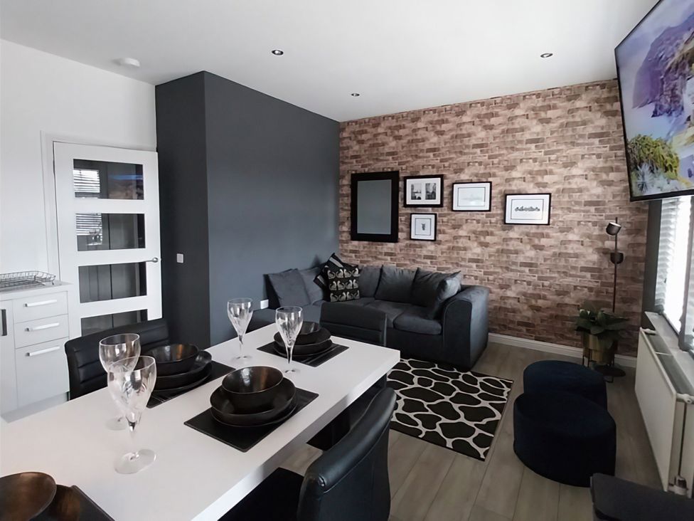 A living room with a dining table and sofa at Modern Apartment - Sleeps 4 - Centrally located in Lanark