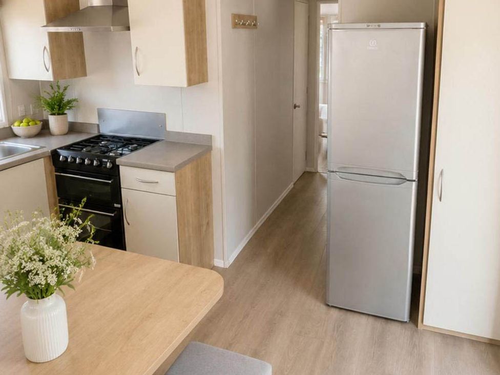 A kitchen with a fridge and stove at Billing Aquadrome Holiday Park - 2 Bedroom, Silver, Northampton