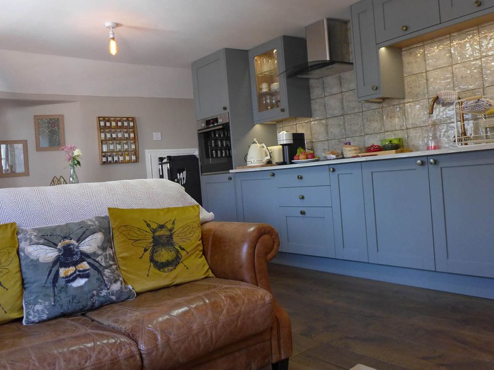 A kitchen with a sofa and cushions at Royal Oak Retreat Sleeps 6 Pub Pet Friendly Barcombe Cross