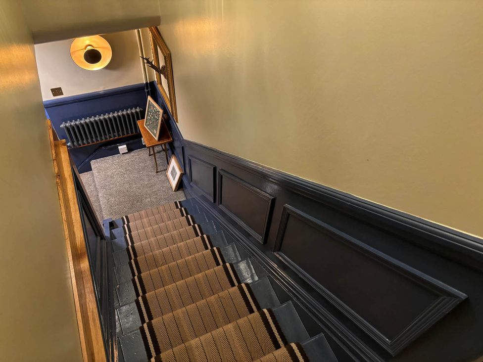 A staircase with a handrail and a light fixture at Royal Oak Retreat Sleeps 6 Pub Pet Friendly Barcombe Cross