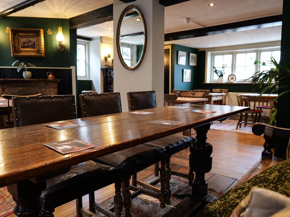A dining room with a wooden table and chairs at Royal Oak Retreat Sleeps 6 Pub Pet Friendly Barcombe Cross