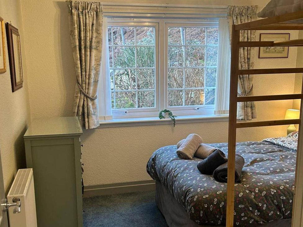 A bedroom with a bed, window, and chest of drawers at Marsco Apartment Garden Patio Sea Views Applecross near Lochcarron
