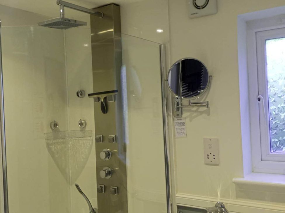 A bathroom with a shower installation at Marsco Apartment Garden Patio Sea Views Applecross near Lochcarron