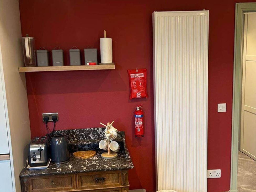 A kitchen with a kettle and toaster on a wooden countertop at Marsco Apartment Garden Patio Sea Views Applecross near Lochcarron
