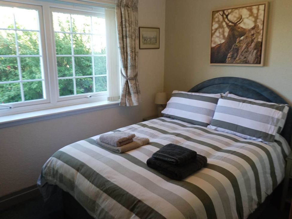 A bedroom with a bed and towels on it at Marsco Apartment Garden Patio Sea Views Applecross near Lochcarron