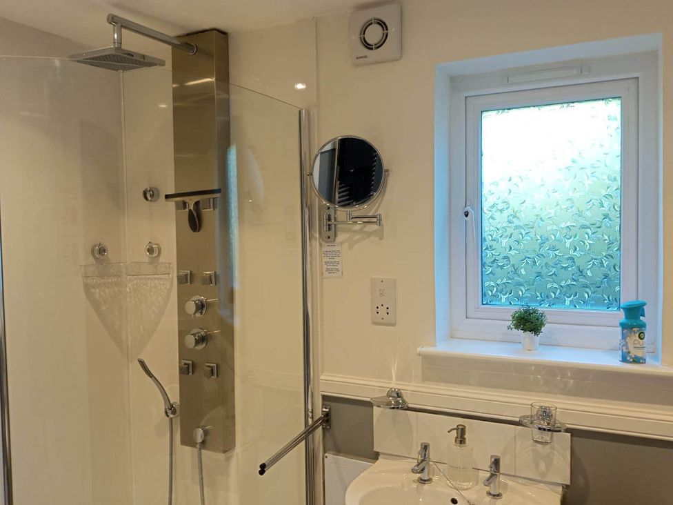 A bathroom with a shower and sink at Marsco Apartment Garden Patio Sea Views Applecross near Lochcarron