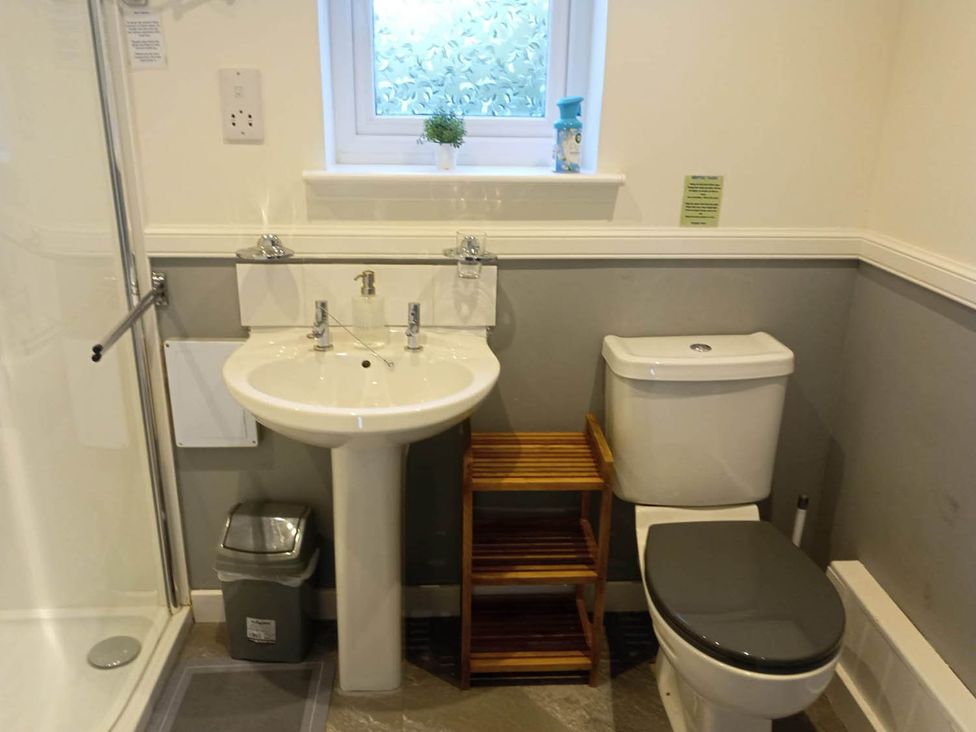A bathroom with sink, toilet, and shower at Marsco Apartment Garden Patio Sea Views Applecross near Lochcarron