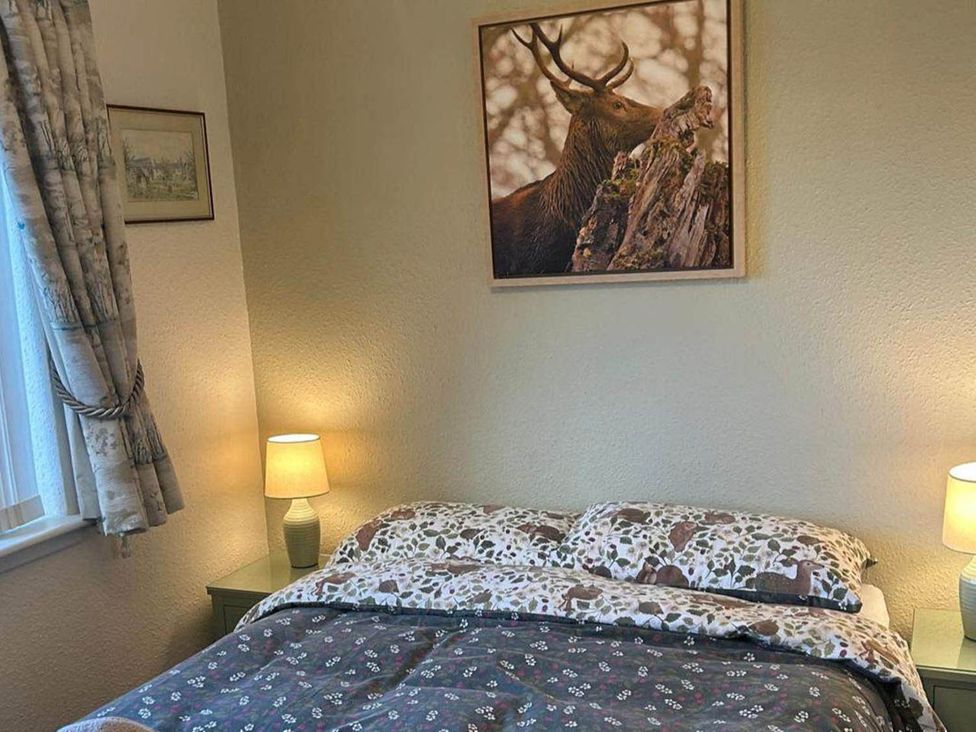 A bedroom with a bed and lamps at Marsco Apartment Garden Patio Sea Views in Applecross near Lochcarron