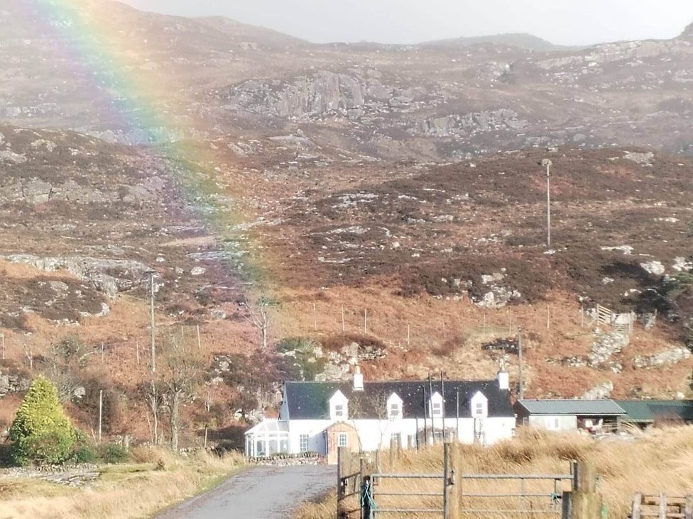 A house with a rainbow in the sky at Marsco Apartment Garden Patio Sea Views in Applecross near Lochcarron