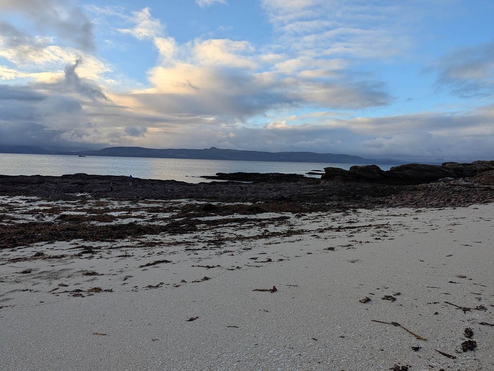 A beach with sand and rocks near the sea at Marsco Apartment Garden Patio Sea Views, Applecross near Lochcarron