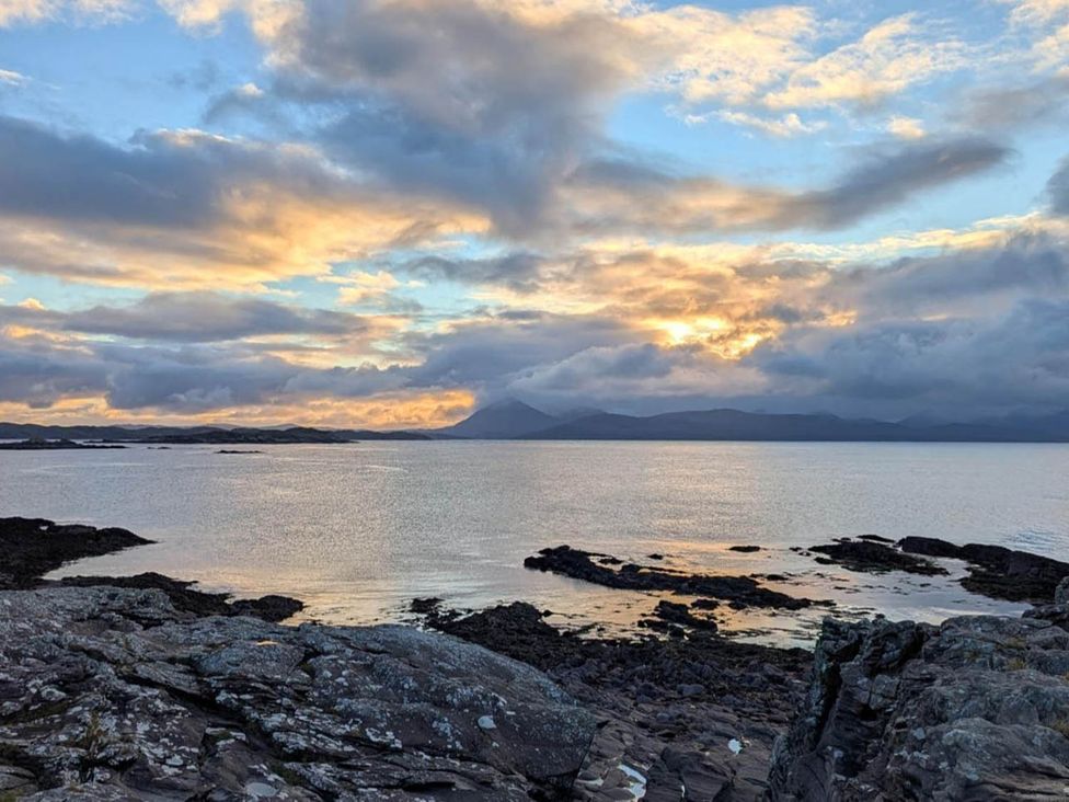 A scenic view of the sea and rocks at Marsco Apartment Garden Patio Sea Views Applecross near Lochcarron