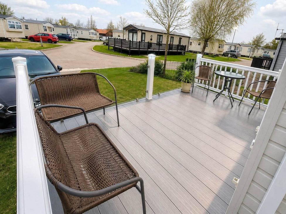 An outdoor area with seating and a table at Tattershall Lakes - Hot Tub - Sleeps 6 - Pets, Tattershall
