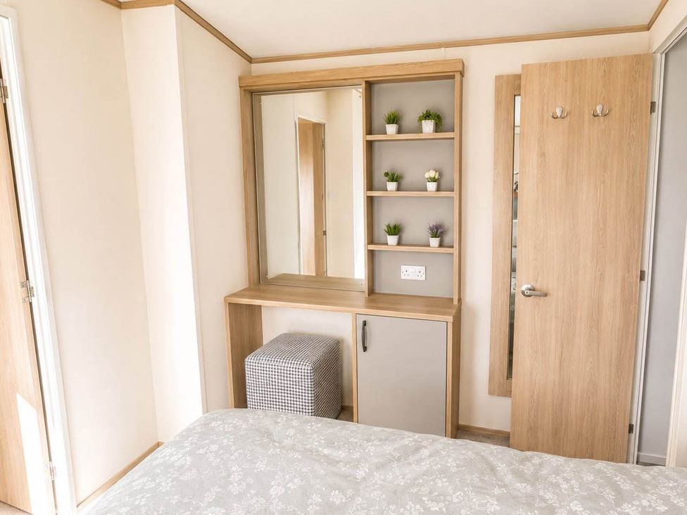 A bedroom with a mirror and shelves at Tattershall Lakes - Hot Tub - Sleeps 6 - Pets, Tattershall