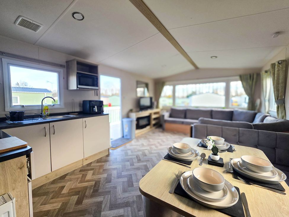 A kitchen with a living area and dining table at Static Caravan 3 Bed Sleeps 8 Dog Friendly Parking Northampton