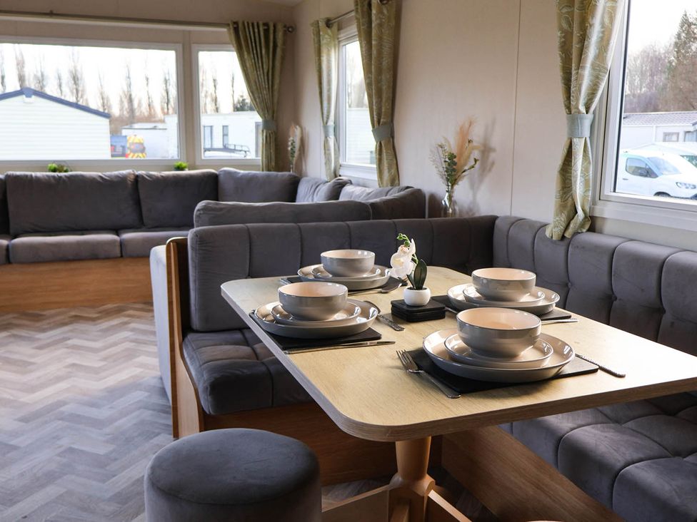 A dining area with a table set for meals at Static Caravan 3 Bed Sleeps 8 Dog Friendly Parking Northampton