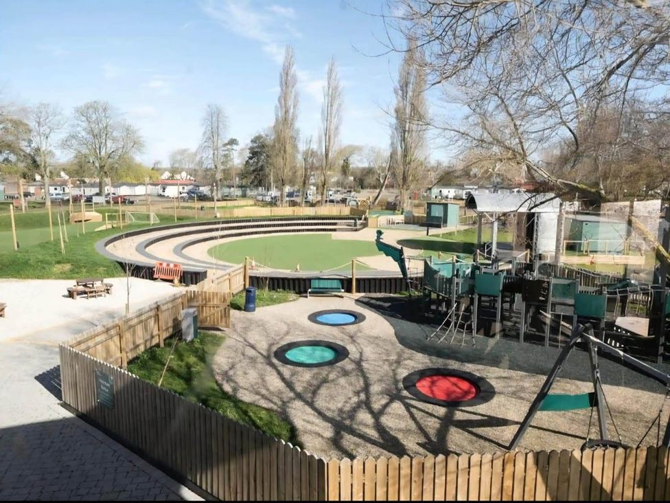A playground with slides, swings, and benches in an outdoor area