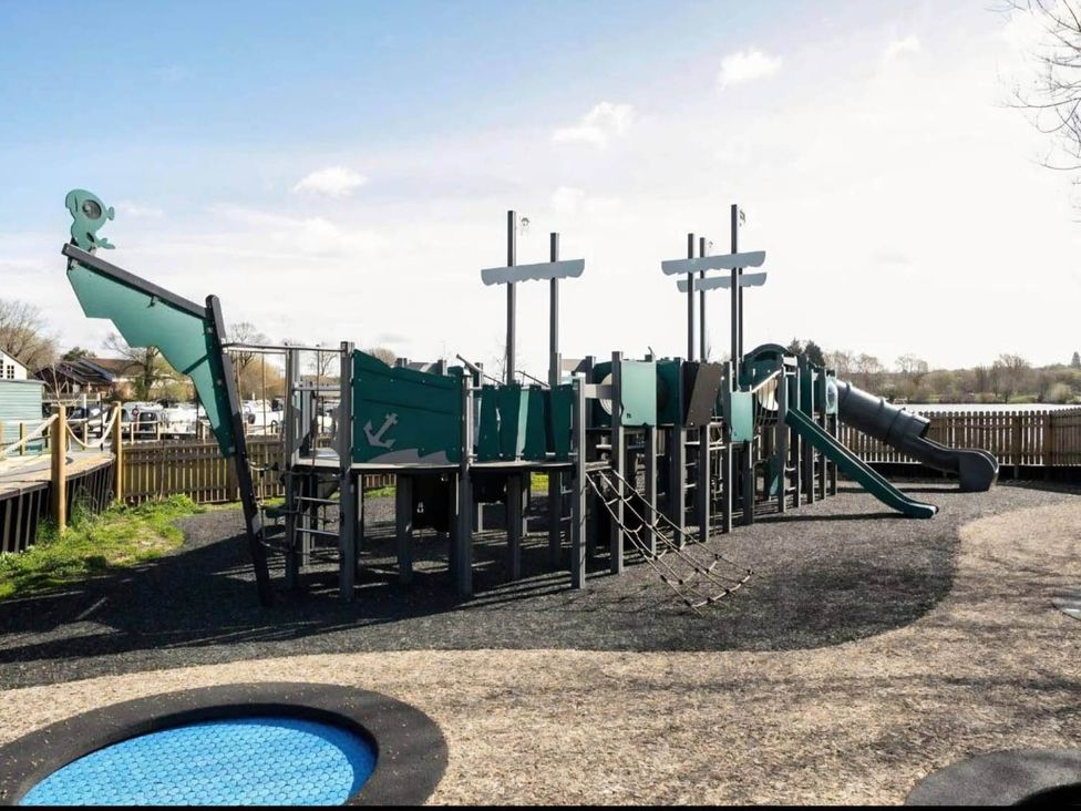 A playground with a climbing structure and slide