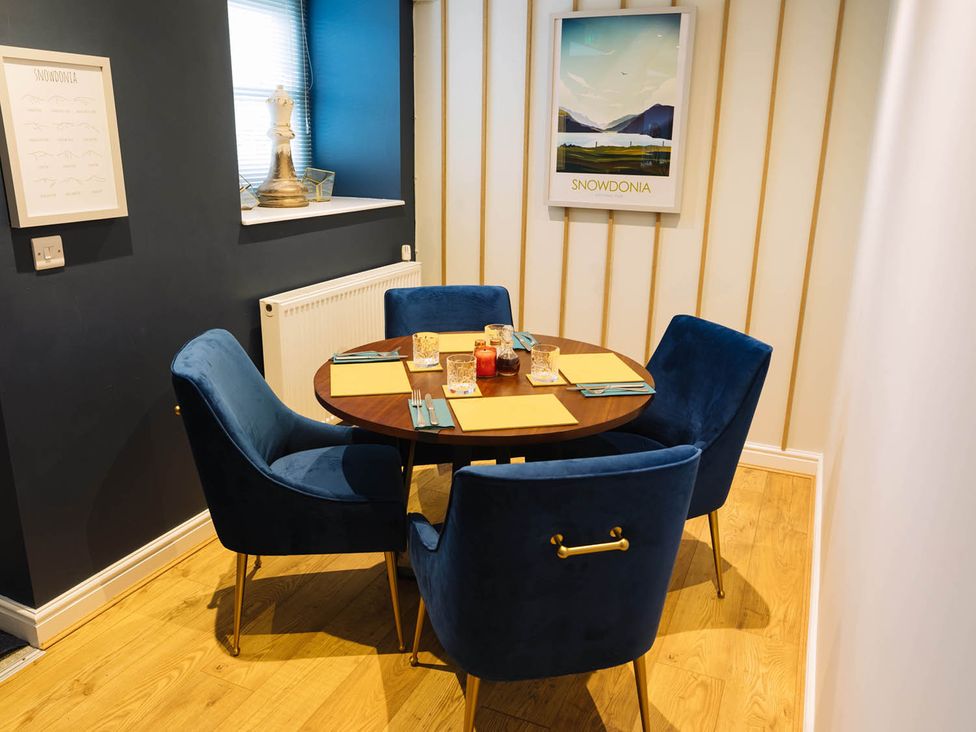 A dining room with a table and chairs at Snowdon Studio Apartment in Tal-y-cafn near Llandudno Junction