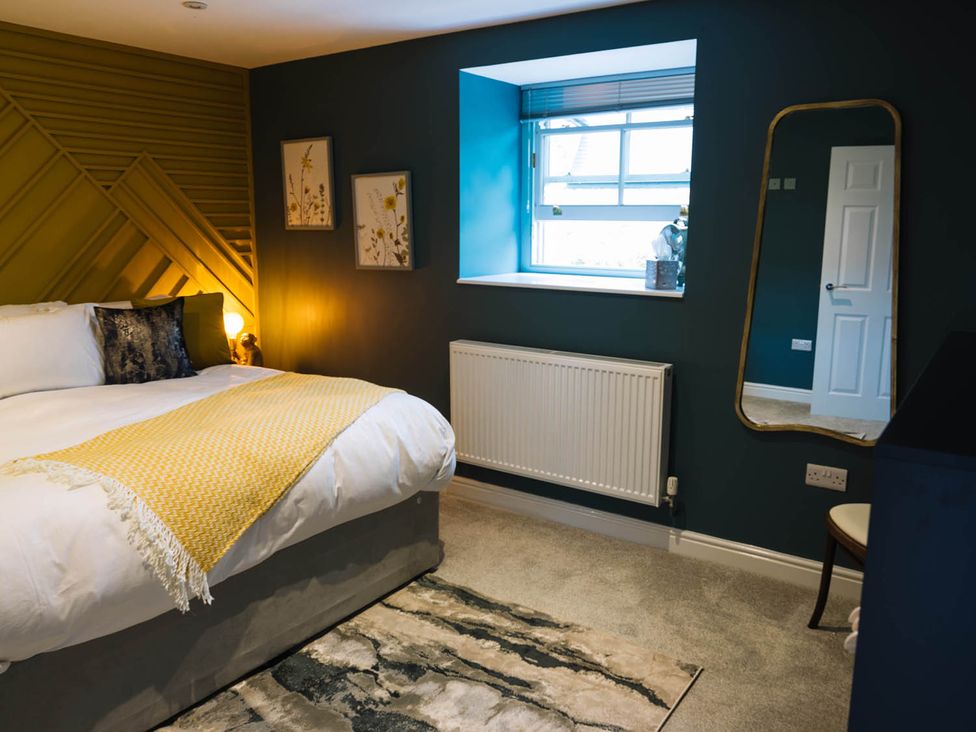 A bedroom with a bed and window at Snowdon Studio Apartment Tal-y-cafn near Llandudno Junction