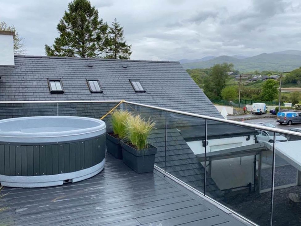 An outdoor area with a hot tub and planters at Snowdon Studio Apartment in Tal-y-cafn near Llandudno Junction