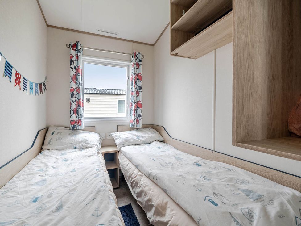 A bedroom with two beds and a window at Cabin - Sleeps 4 - Pets Ok - Balcony - Parking, Haven Park, Doniford Bay near Watchet