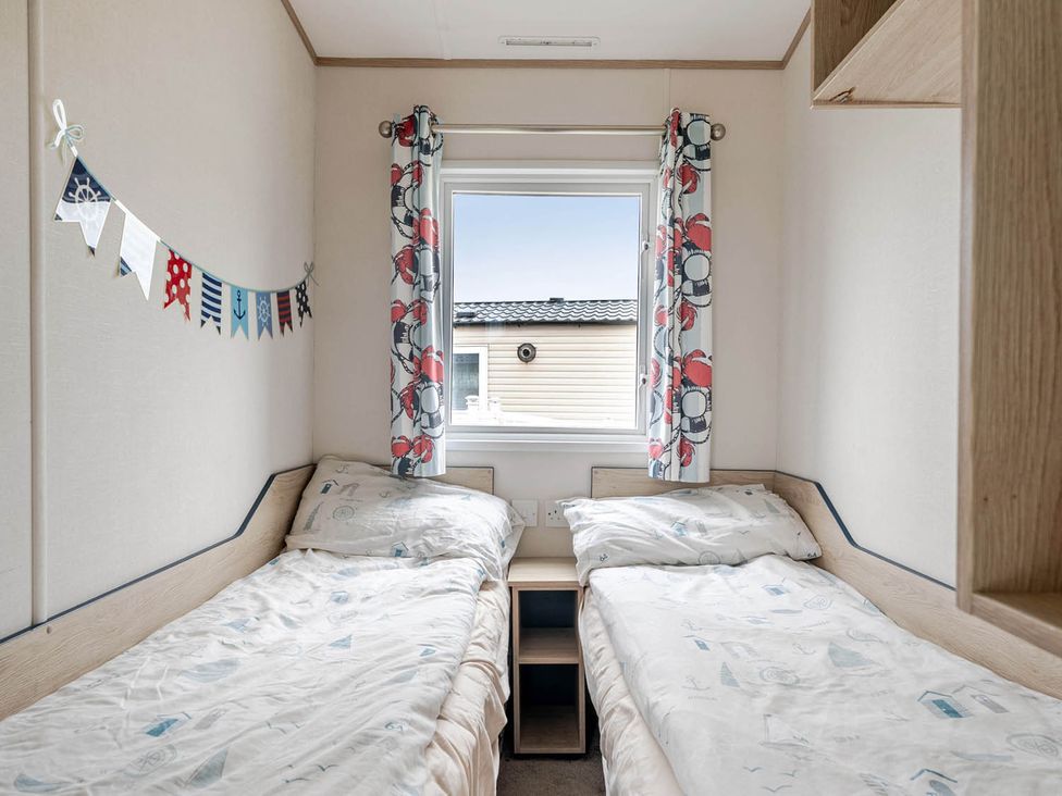 A bedroom with two beds and a window at Cabin - Sleeps 4 - Pets Ok - Balcony - Parking, Haven Park, Doniford Bay near Watchet