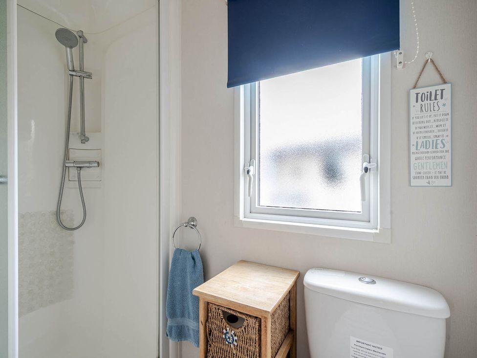 A bathroom with a shower and toilet at Cabin - Sleeps 4 - Pets Ok - Balcony - Parking in Haven Park, Doniford Bay near Watchet