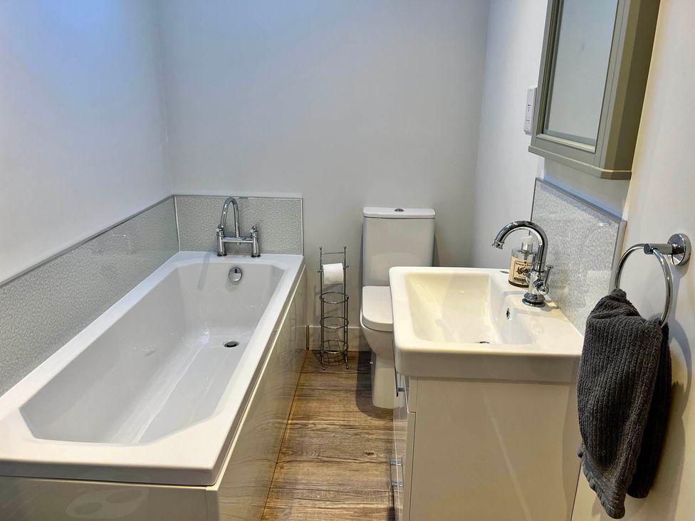 A bathroom with a bathtub, sink, and toilet at Cottage Sleeps 6 Garden Parking Beaulieu Farm near Coleford