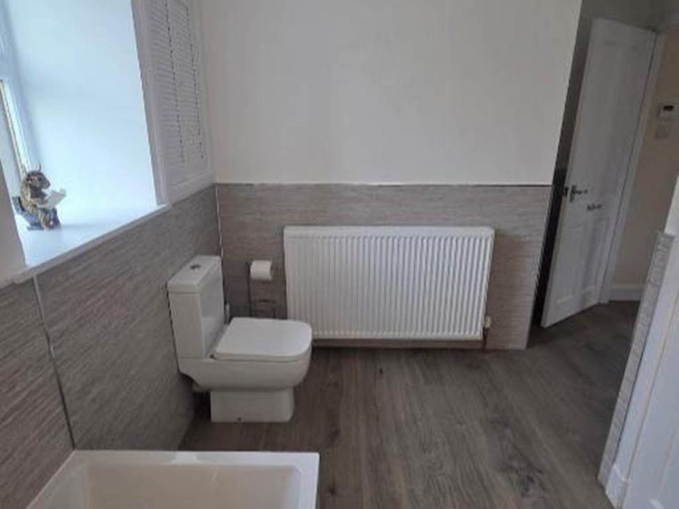 A bathroom with a toilet and bathtub at Farm Cottage at foot Angus Glens near Kirkton of Kingoldrum