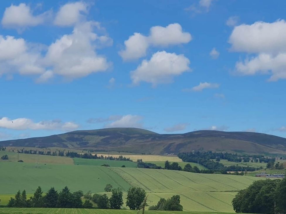 A landscape with mountains and fields at Farm Cottage at foot Angus Glens Kirkton of Kingoldrum near Kirriemuir
