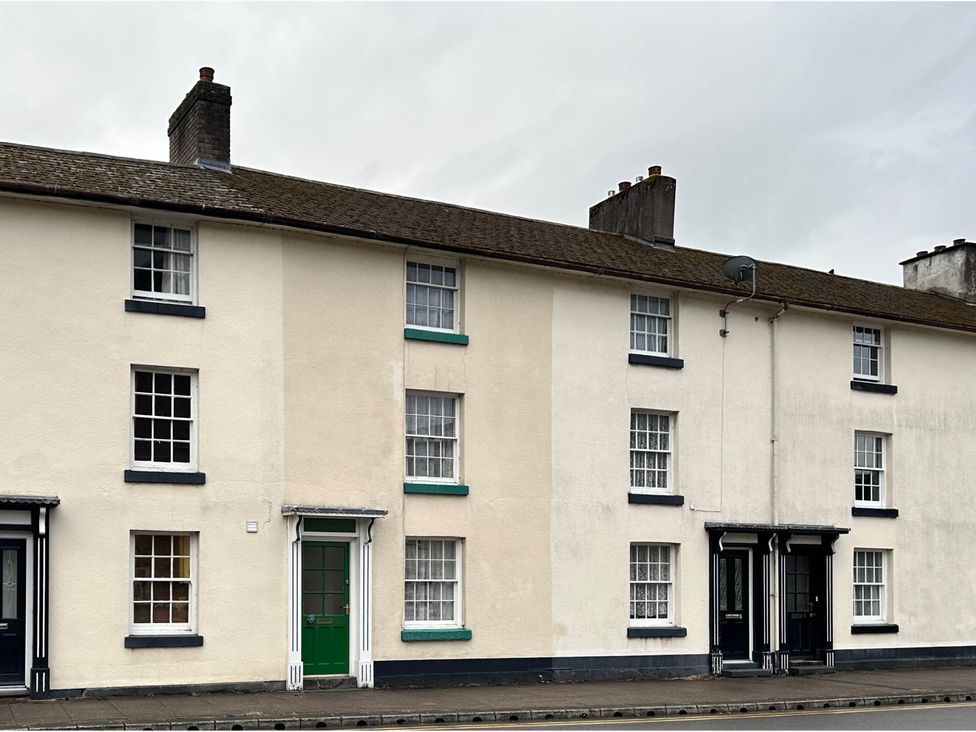 A row of houses with different colored doors in Llanidloes