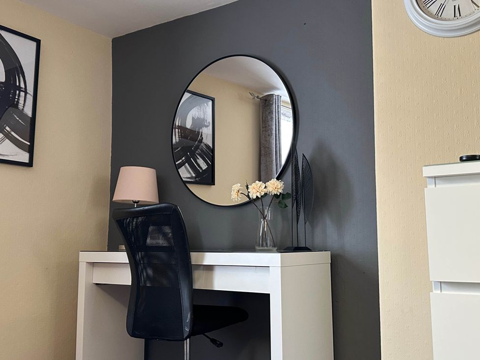 An office with a desk, chair, lamp, and wall art at Llanidloes - Sleeps 7 - Parking - Pet Friendly, Llanidloes