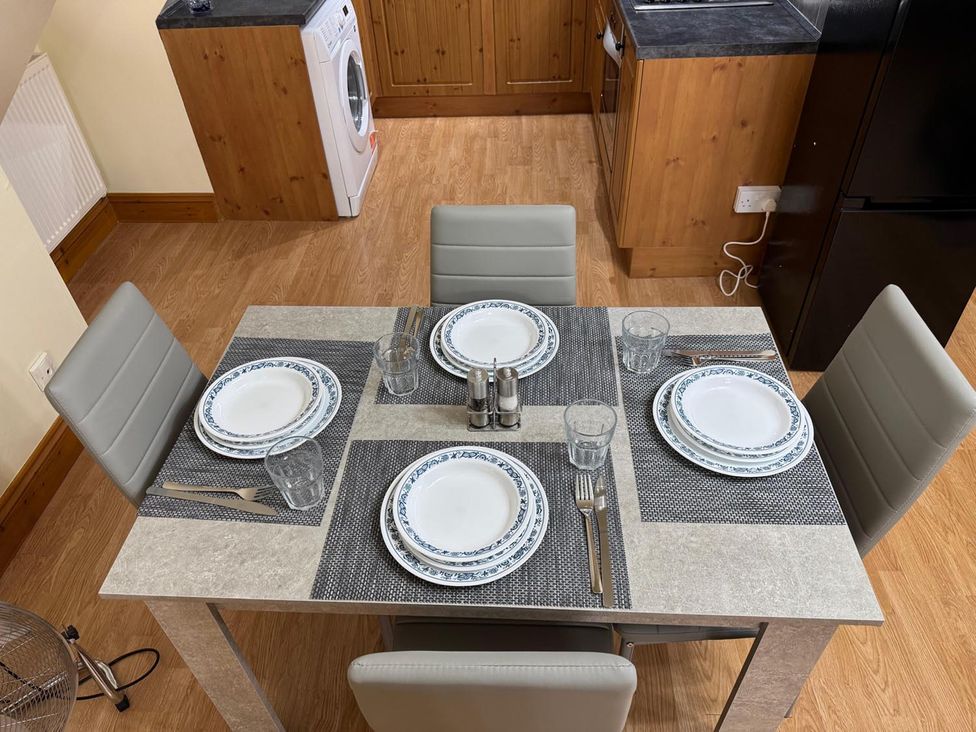 A dining table set with plates and glasses in Surridges Studio, Sleeps 4 w/ Parking & Dogs Ok, Latchingdon near Burnham-On-Crouch