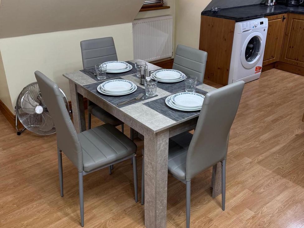 A dining table set with plates and glasses in Surridges Studio, Sleeps 4 w/ Parking & Dogs Ok, Latchingdon near Burnham-On-Crouch